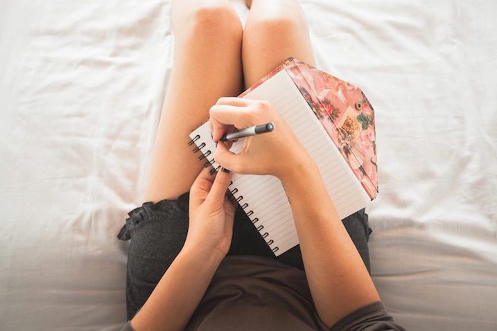 woman-writing-journal-bed